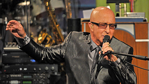 Paul Shaffer of Late Night singing into a mic