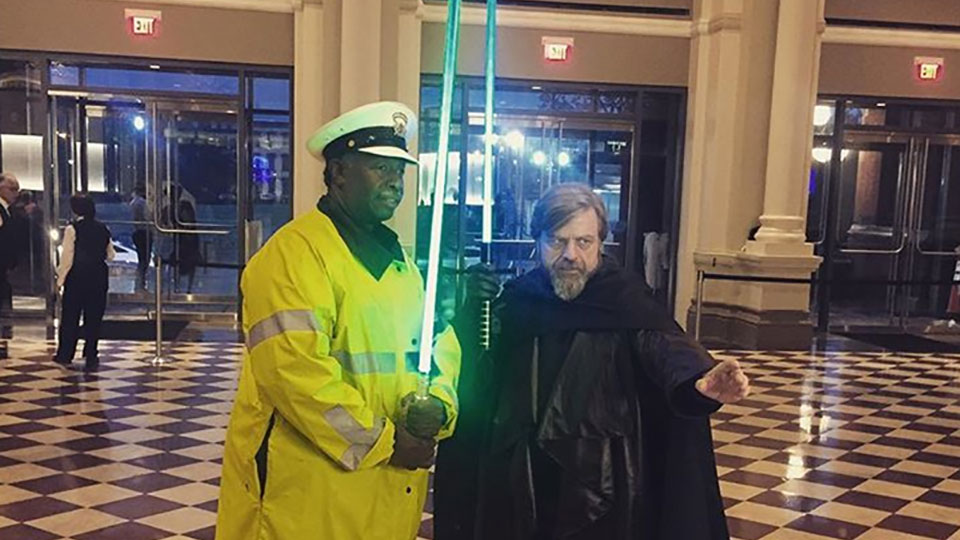 Fluke Skywalker and and polica officer holding lightsabers