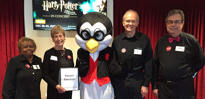 Pops mascot Tempo the Penguin poses with CSO volunteers